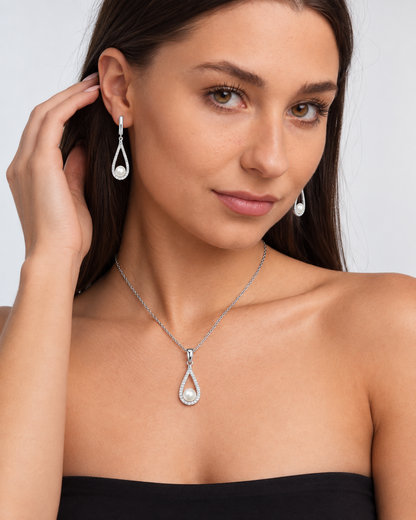 Pearl Teardrop Necklace & Earring Set in Silver, worn by a model in a three-quarter portrait - Vessaly