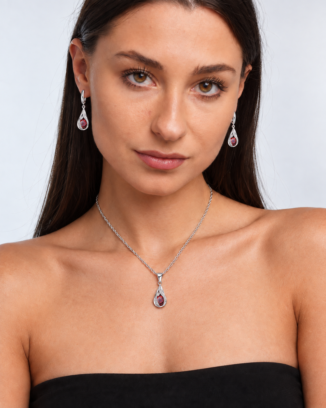 Twist Teardrop Crystal Necklace & Earring Set in Red, worn by a model in a front portrait - Vessaly