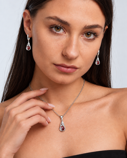 Twist Teardrop Crystal Necklace & Earring Set in Red, worn by a model in a close-up - Vessaly
