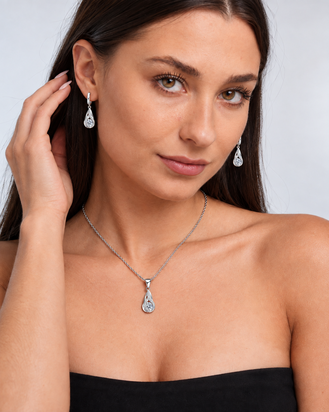 Twist Teardrop Crystal Necklace & Earring Set in Clear, worn by a model in a three-quarter portrait - Vessaly