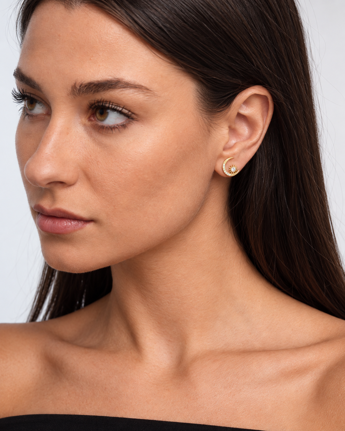 14K gold-plated star and moon stud earrings worn by a brunette model - crescent close-up